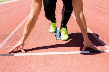 Athlete on a starting block about to run