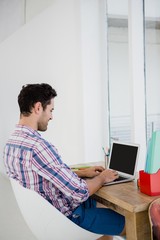 Fototapeta premium Young man working at his desk