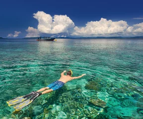 Türaufkleber man snorkeling in clear tropical waters over coral reefs © soft_light
