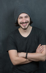 Portrait of a fashionable young man on dark background, chalkboa