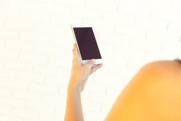 Woman with modern mobile phone in hands