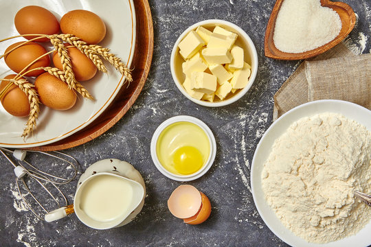 Ingredients for baking. Baking background with eggs, flour and pitcher milk, butter. Top view. Rustic style.