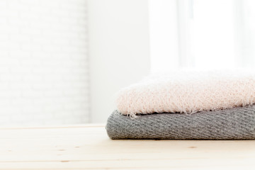 Obraz na płótnie Canvas Stack of white cozy knitted sweaters