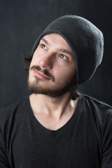 Fototapeta premium Portrait of a fashionable young man on dark background, chalkboa