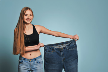 Fit young woman in loose jeans