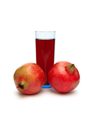 ripe pomegranate and glass of juice isolated on white background