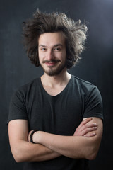 Portrait of a fashionable young man on dark background, chalkboa