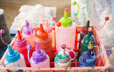 paintbrush and bottles with dyes for cold batik