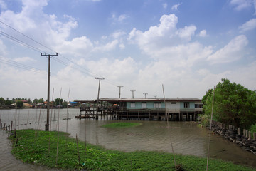 Obraz premium Stilt houses built above river at Thailand.