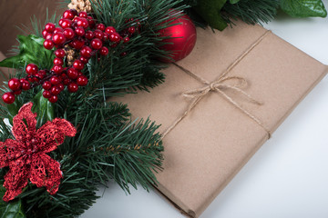 Fototapeta na wymiar Kraft gift box with christmas balls and tag on a white background