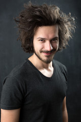 Obraz premium Portrait of a fashionable young man on dark background, chalkboa