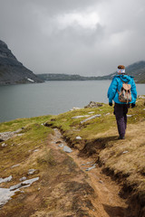 hiking to a foggy mountain lake