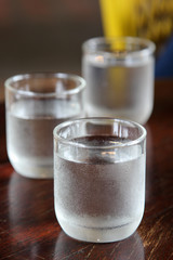 Glass of cold fresh water on wooden table.