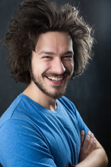 Portrait of a fashionable young man on dark background, chalkboa