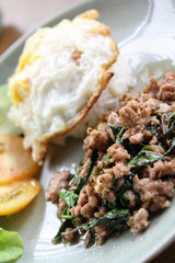 Stir-fried pork with basil leaves and fried egg on rice.