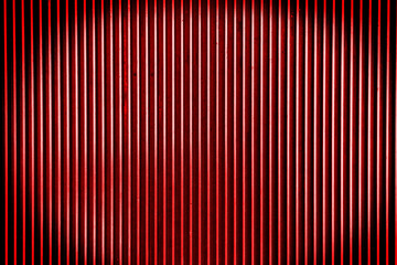 Red metal steel background with bright center spotlight and blac