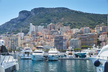 Papier Peint photo Porte Monaco, Monte-Carlo, Monaco Ville, 8 August 2016: Port Hercules, the preparation of the yacht show MYS, sunny day, many yachts and boats, RIVA, Prince's Palace of Monaco, megayachts, Massif of houses