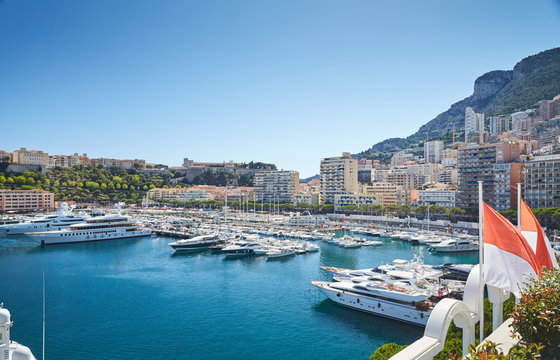 Monaco, Monte-Carlo, Monaco Ville, 8 August 2016: Port Hercules, the preparation of the yacht show MYS, sunny day, many yachts and boats, RIVA, Prince's Palace of Monaco, megayachts, Massif of houses