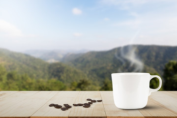 Computer laptop with black screen and hot coffee cup on wooden table top on blurred lake and forest background