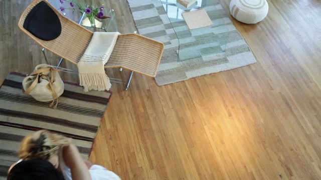 Couple dancing accross floor at home, high angle view