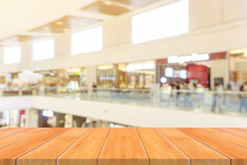 Wooden board empty table blurred background. Perspective brown wood over blur in department store - can be used for display or montage your products.Mock up for display of product.