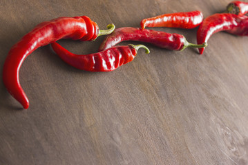 chili peppers on a  wooden background
