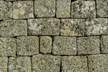texture with the blocks of manposteria of the walls of the medieval castle of the town of Monsanto, Portugal