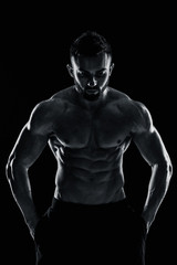 Fototapeta na wymiar very muscular man posing with naked torso in studio