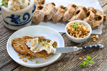 Deftiges Griebenschmalz im Schmalztopf mit rustikalem Brot serviert - Hearty lard with greaves and onions in a rustic stoneware pot served with fresh corn bread
