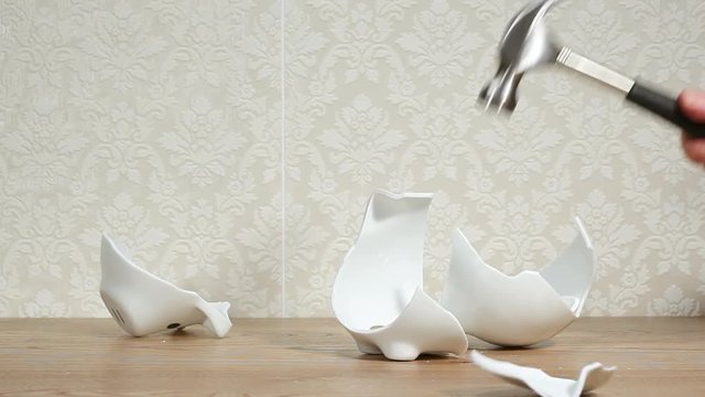 Man smashing piggy bank