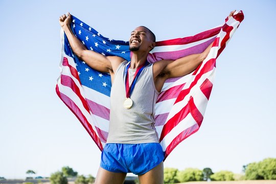 Athlete posing with American flag 