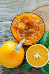 Oranges and bowl with jam.