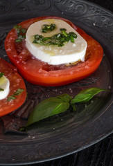 Caprese salad with mozzarella cheese, tomatoes and basil