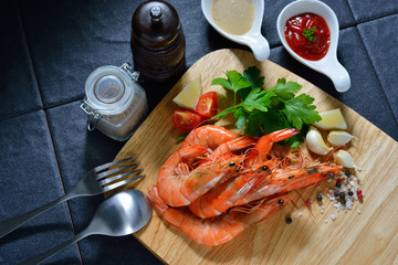 Cooked shrimps,prawns with seasonings on chopping board