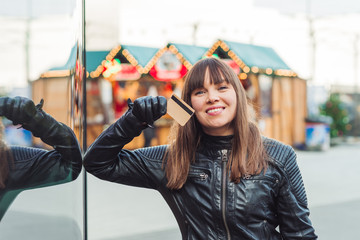 Fototapeta premium beautiful woman with shopping bags and credit card on christmas market
