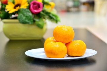 Oranges on a plate on the table