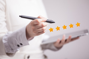 Five star rating or ranking, benchmarking concept. Woman assesses service, hotel, restaurant
