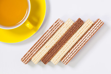 Perfect cup of tea on wooden table with sweet wafers