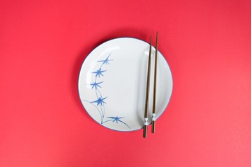 Plates and bowls, chopsticks prepared for the Chinese people.pink background