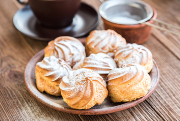 Delicious profiteroles with cream dessert.