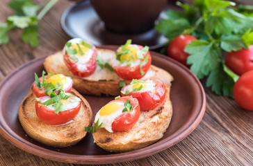 Baked eggs in tomato cups. Breakfast.