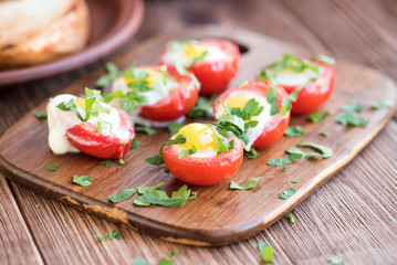 Baked eggs in tomato cups. 