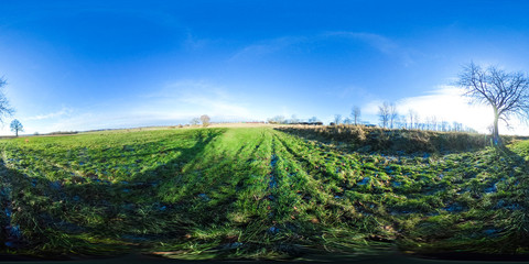
360 degrees spherical panorama of green fields  and blue sky in autumn