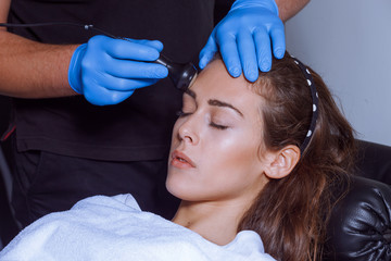 woman face treatment at spa center