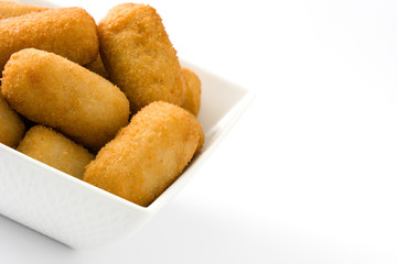 Traditional fried Spanish croquetas (croquettes) on wooden background
