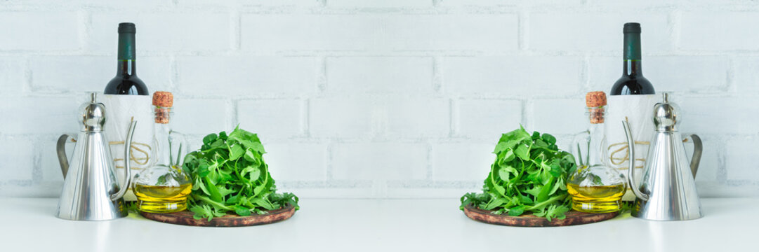 ottle of wine, vinegar, olive oil and green salad leaves - concept of healthy food, italian cuisine, restaurant. Wide panoramic.