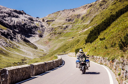 Famous Passo Dello Stelvio Road in Swiss - Italy border. Favourite place for all bike riders. Alone biker on the top.