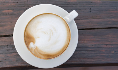 Close up white cup of Coffee, latte on the wooden table