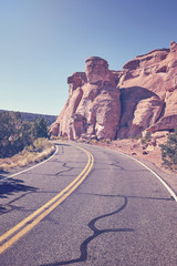 Retro toned scenic road, travel concept background, Colorado National Monument, Colorado, USA