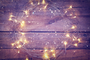 Christmas tree garland lights on wooden background